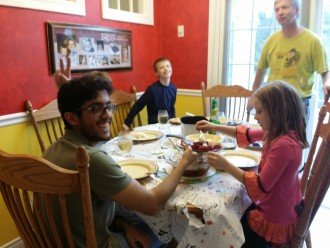Tariq with host family at dinner table