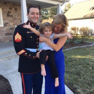 Patrick McConnell wears his Marine Corps uniform while posing for a picture with his young daughter and fiancee.