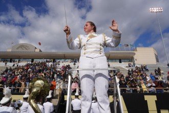 A drum major directs a marching band.
