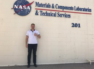 Jacob Ganzak stands outside a NASA building.