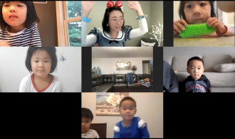 A screenshot of a video chat with several young students.