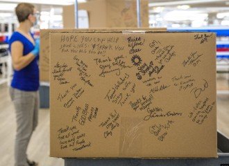 A cardboard box signed by people who helped make ventilators.