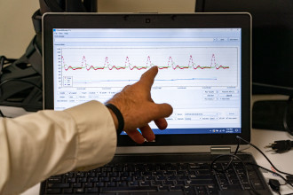 Dr. Daryl Lawson points to a graph on a computer screen.