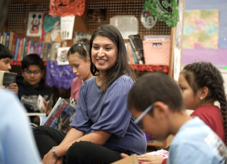 Zenia Gutierrez sits with a group of students.
