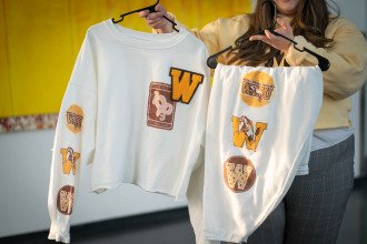 A long-sleeved shirt and pants decorated with Western Michigan University logos.
