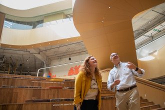Sara Bamrick and Paul Terzino stand on the gathering stairs in the WMU Student Center.
