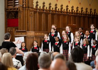 A children's choir sings in a church.