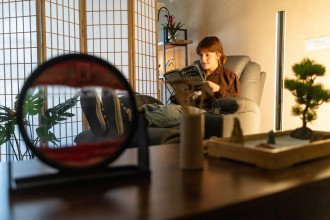 A student sits in a chair and reads.