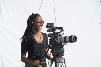 Tirrea Billings with a camera filming