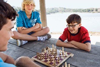 Photo of young boys playing chess.