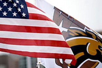 Photo of American flag with WMU flag behind it.