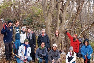 Photo of faculty, staff, students, alumni and volunteers in front of the large dwarf hackberry tree.