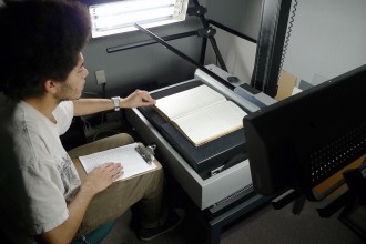 Photo of student assistant Lawrence Stout working on the digitization project.