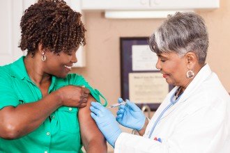 Photo of a woman getting an influenza vaccine.