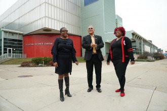 Lisa Williams, President Montgomery and Tennie Jackson stand outside the Michigan Science Center.