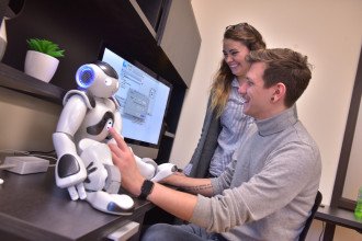 Students working with social robots.