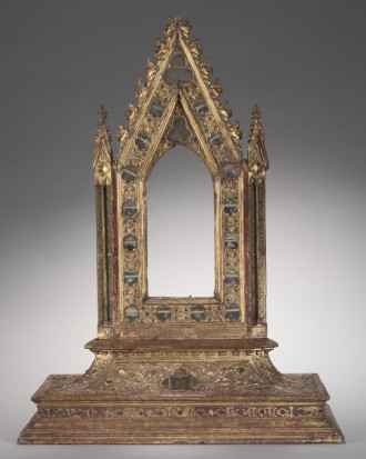 An empty frame for a portable reliquary icon dating to 1347, made of wood, modeled gesso, verre églomisé, glass cabochons, and relics. Surrounding the empty space within the frame are seventeen relics, still visible. A Latin inscription around the base reads: This work has been made under the year of the Lord CCCXLVII [1347] in the time of the Lord Mini/Cini. The coats of arms of Cinughi and the hospital are visible on the base. Another inscription, LUCAS ME FECIT (Luke made me), is written on both sides of the base.