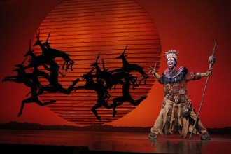 Photo of Buyi Zama in costumeas Rafiki in the musical "The Lion King."