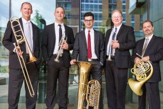 Photo of members of the Wisconsin Brass Quintet standing and holding their instruments