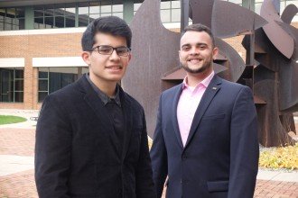 WMU students Abrahan Garcia and Alex Gutierrez-Spencer standing outside of WMU's Schneider Hall, home to the business college.