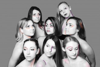 Black and white photo of eight female WMU dance students clustered together and looking off in different directions.