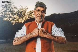 Photo of Nobel Peace Prize Laureate Kailash Satyarthi holding his fists together with the words Freedom is non-negotiable written on his arms.