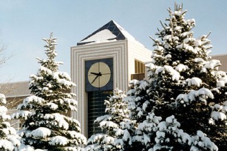 Stewart clock toer at Waldo Library with snow-covered trees.