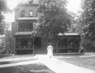 Woman outside Mitchell Cottage