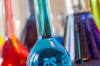 Chemistry beakers filled with colorful liquids.