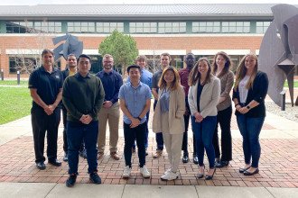 Dr. Sime Curkovic and supply chain students who worked with Fusion Management Partners stand outside in the Haworth College of Business courtyard.