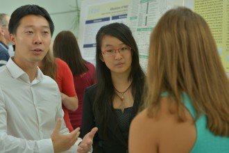 Students describing research posters