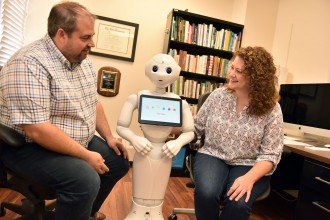 Photo of Drs. Chad and Autumn Edwards working with Pepper at WMU.