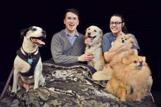 WMU theatre students pose on-stage with a few dogs.