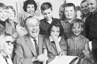 Walt Disney signs autographs for children during a visit to the Kalamazoo Institute of Arts in 1964.