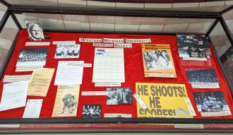 An image of Page's Western Michigan University Hockey exhibit, filled with photographs and letters documenting the team's progression and success.