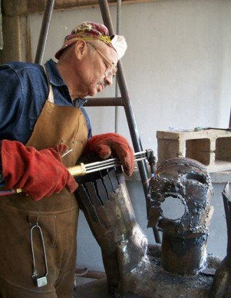 Retired WMU professor Albert LaVergne works on a metal scultpure.