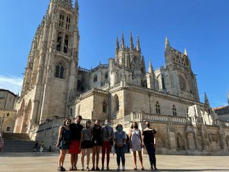 Group of students standing in front of Spanish cathedral. 