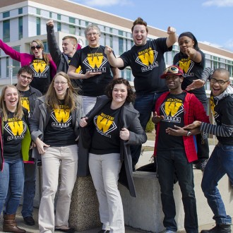group students and staff wearing Heroes t-shirts and displaying pride on the WMU campus