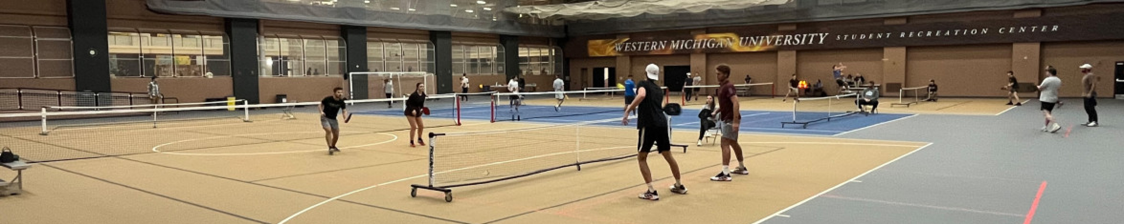 Group of people playing Pickleball on the pickleball court.