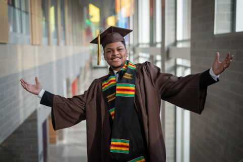 A student in his graduation cap and gown.