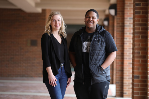 Donte' Tuggle and Erika Hejl poses outside of Schneider hall. Donte' secured a job with Nike and Erika found employment with Smucker’s through their education and opportunities provided by WMU.