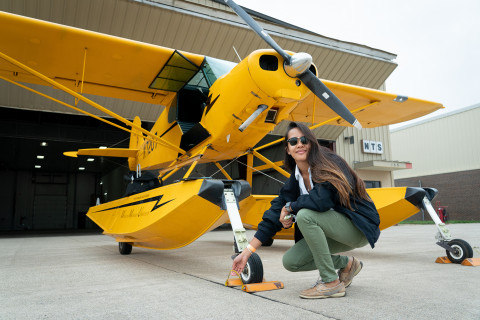 Student near her airplane preparing for a flight.