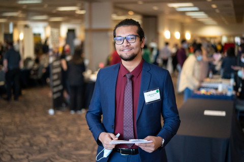 Career and employment services on campus. Job fair on campus, a male student smiling.