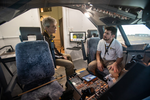 Flight Science student with instructor in a cockpit.