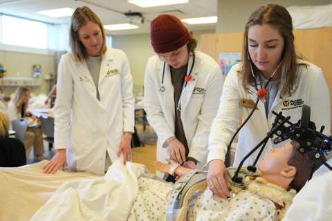 Nursing students in a classroom lab.
