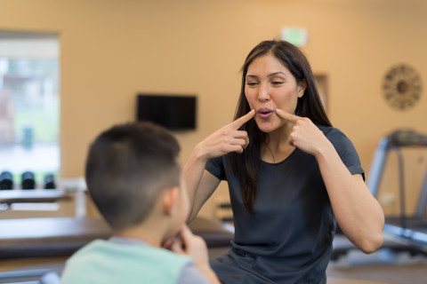 Therapist working with a child with speech.