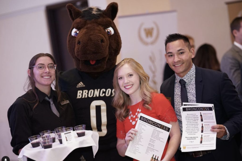 Students stand with Buster Bronco.