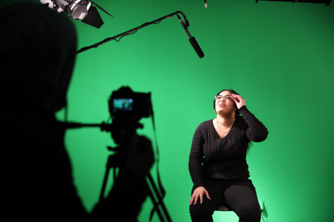 Student in green screen room
