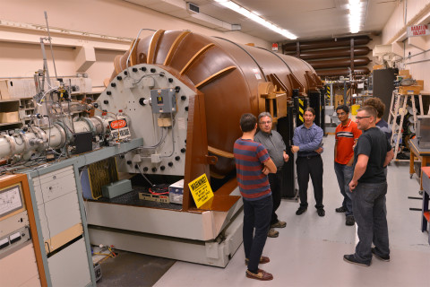 Faculty with the particle accelerator