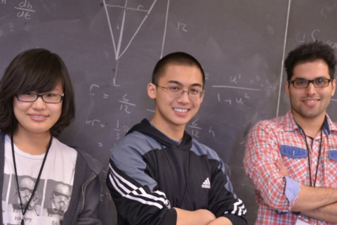 Students standing in front of chalk board